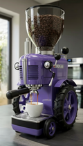 Purple coffee grinder with a glass container of coffee beans and a cup of coffee being brewed.